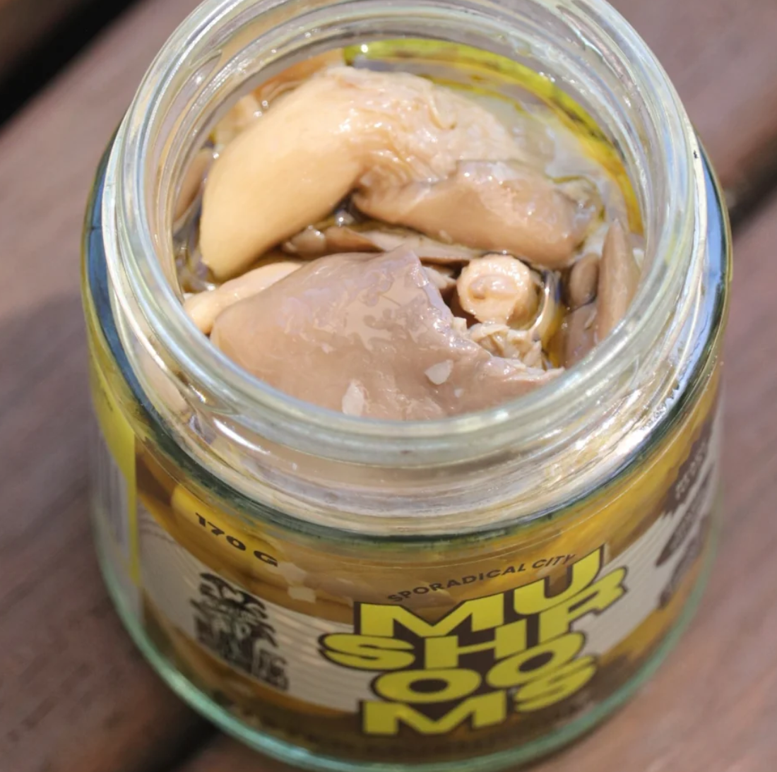 OMG Mushroom Confit in an open 130g jar, showing the mushroom confit inside.