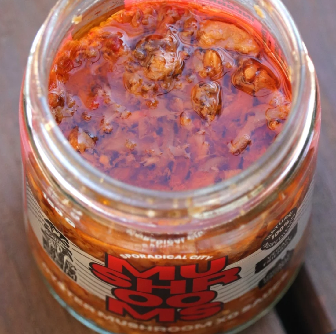 Umami Bomb OM XO Sauce in an open 150g jar, showing the mushroom chilli sauce inside.